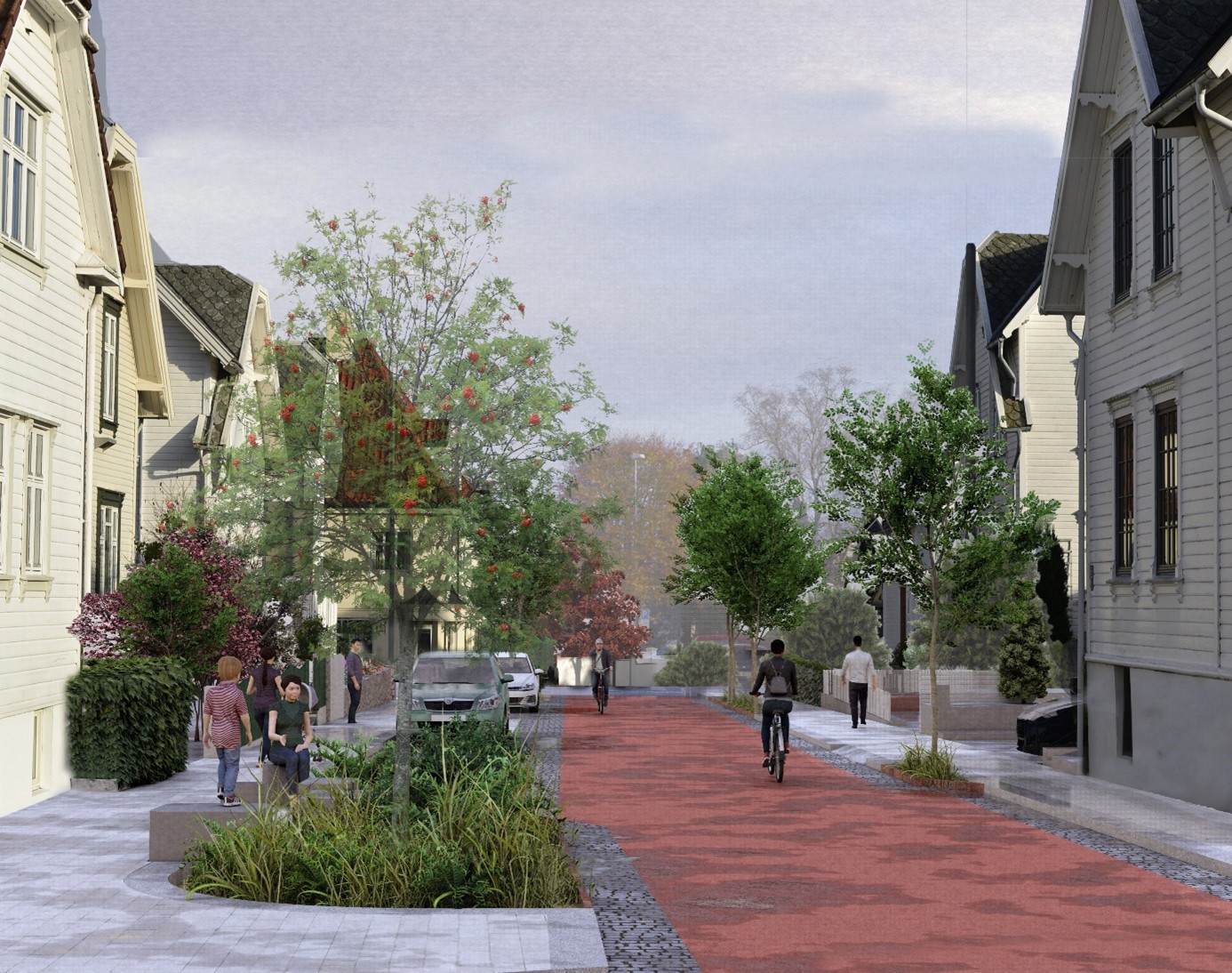 Syklist i bygate med rødt dekke, som viser sykkelprioritert gate