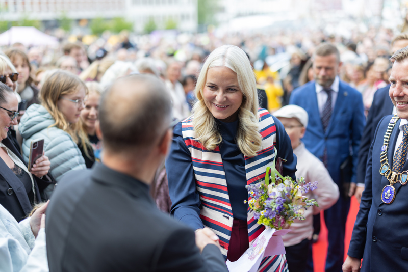 Kronprinsessen hilser på en person i en folkemengde i Stavanger. 