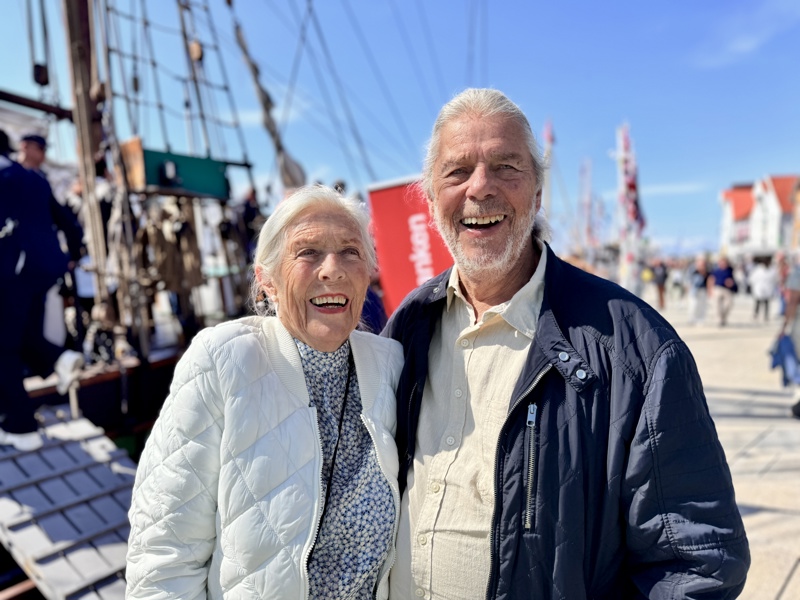 En eldre kvinne smiler ved siden av en eldre mann. 