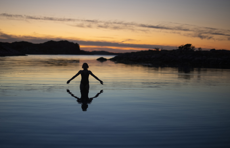 Bading i speilblankt vann