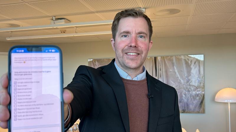 Ordfører Tormod Losnedal holder og viser fram mobilen sin med tiltakene i Stavangeravtalen