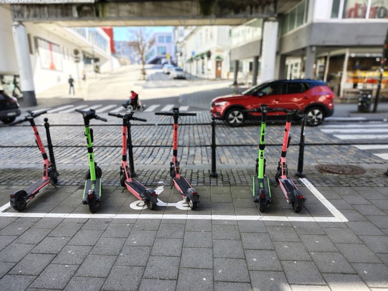 mange elsparkesykler står parkert i klubbgata på oppmerket område
